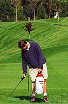 Landscaper spraying chemicals on the golf course